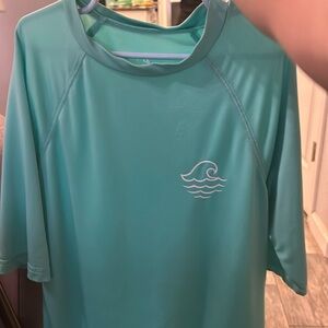 A swim shirt with a light blue color